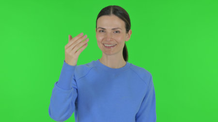 Woman inviting People on Green Backgroundの写真素材