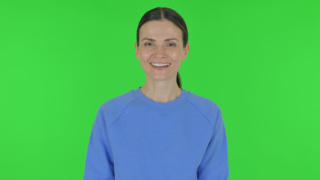 Smiling Woman on Green Background, Portraitの写真素材