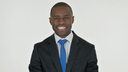 Portrait of African Businessman Shaking Head in Acceptance on White Backgroundの写真素材