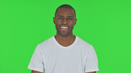 Portrait of Smiling African Man on Green Backgroundの写真素材