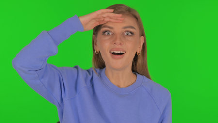 Woman Searching New Opportunity on Green Backgroundの写真素材