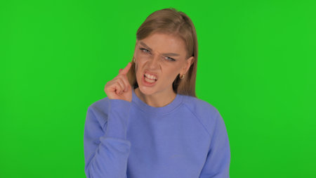 Angry Woman Talking in Anger on Green Backgroundの写真素材