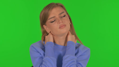 Woman with Neck Pain on Green Backgroundの写真素材