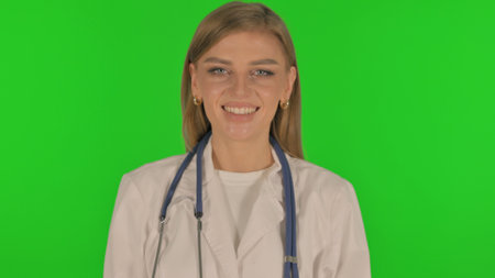 Portrait of Smiling Female Doctor on Green Backgroundの写真素材