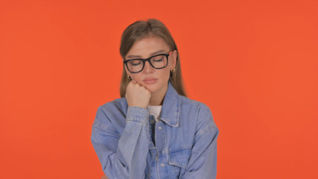 Casual Young Woman on Orange Background, Portraitの写真素材