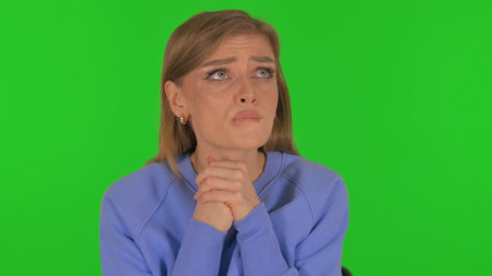 Scared Woman Worried on Green Backgroundの写真素材