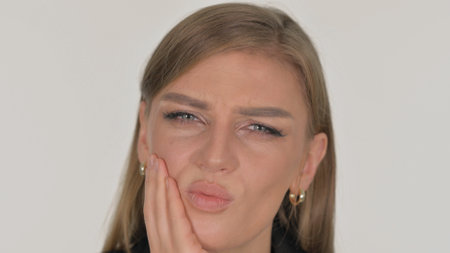 Close up of Woman with Tooth Pain on White Backgroundの写真素材