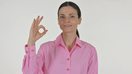 Portrait of Business Woman with Okay Sign on White Backgroundの写真素材