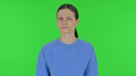 Rejecting Woman Disliking Offer on Green Backgroundの写真素材