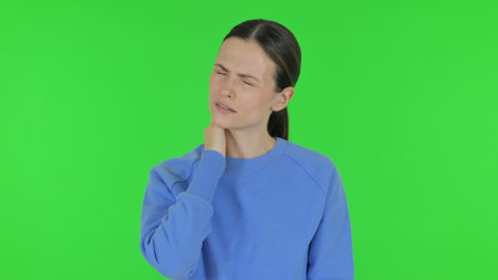 Woman with Neck Pain on Green Backgroundの写真素材