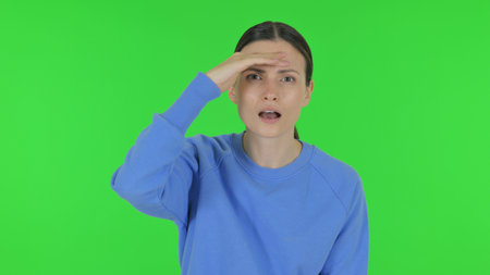Woman Searching New Opportunity on Green Backgroundの写真素材