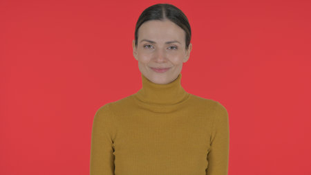 Rejecting Casual Young Woman Disliking Offer on Red Background, Portraitの写真素材