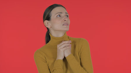 Casual Young Woman Feeling Scared on Red Background, Portraitの写真素材