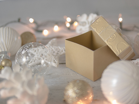 Open gold gift box with Christmas decoration and lights backgroundの写真素材
