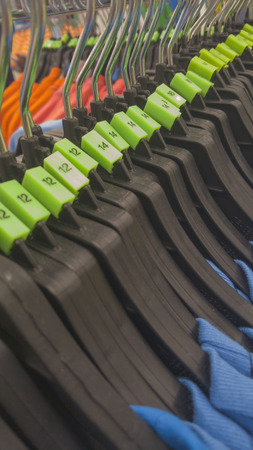 Clothes hanger on a clothes rack in fashion clothes store.の写真素材