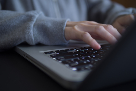 Hand of freelancer working on laptop at home.の写真素材