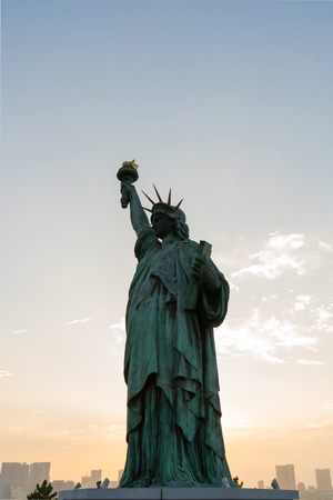 Statue of liberty at sunsetの写真素材