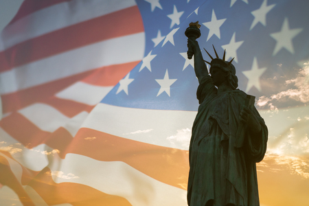 Double exposure with statue of liberty and American flag.の写真素材