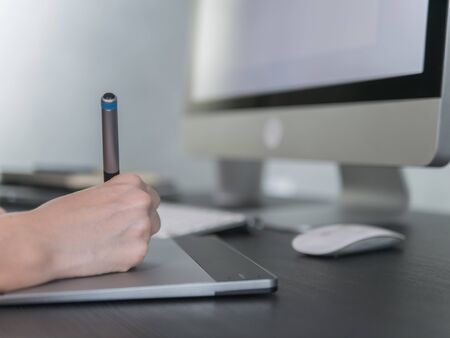 Graphic designer working with pen in the office.