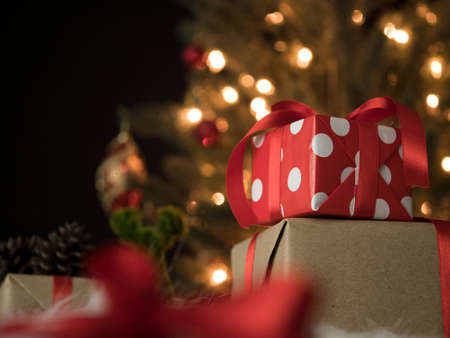Gift boxes against a bokeh background of christmas lights.の写真素材