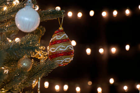 Christmas ball hang on fir tree with bokeh lights background with copy space for your text.の写真素材
