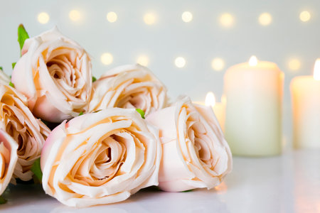 Valentine day and wedding with pink rose in pastel color, candle light in bokeh light background.の写真素材