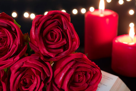Beautiful red rose with romance candle lights on bokeh light background. Valentine's day and wedding...