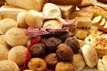 A collection of savoury and sweet baked goods on an isolated white background