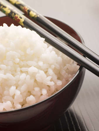 Bowl of Koshihikari Rice with chop sticksの写真素材