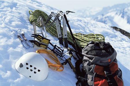 Mountain climbing equipment on a snowy mountain (selective focus)の写真素材