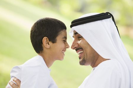 Man and young boy outdoors in park smiling (selective focus)の写真素材
