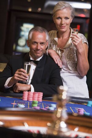 Couple in casino playing roulette and smiling (selective focus)の写真素材