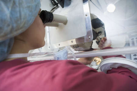 Embryologist adding sperm to eggの写真素材