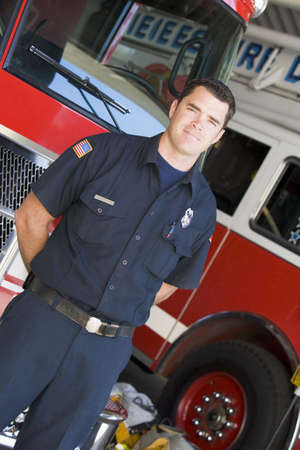 Fireman standing in front of fire engines