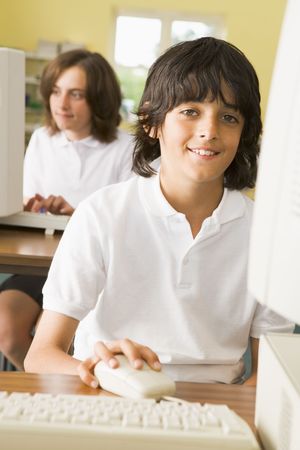 Student at computer terminal with student in background (selective focus)