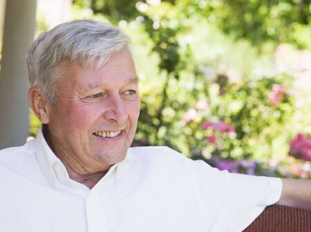 Senior man sitting outdoorsの写真素材