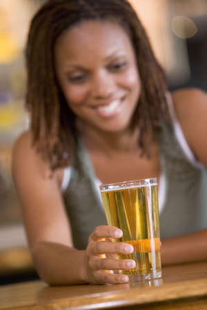 Woman having a glass of beerの写真素材