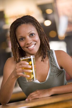 Woman having a glass of beerの写真素材