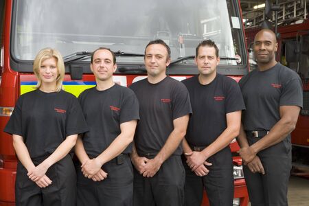 Five firefighters standing in front of fire engine