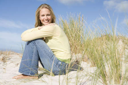 Young woman posing on a sand hillの写真素材