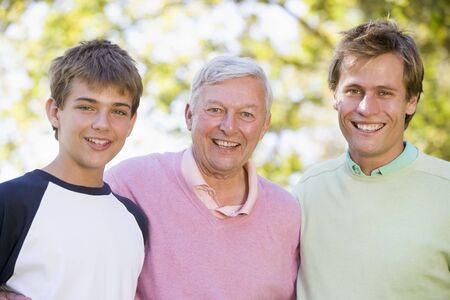 Grandfather with son and grandson smiling.