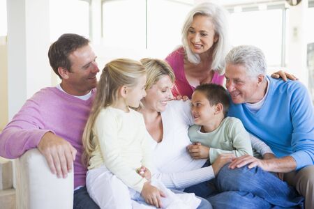 Family sitting indoors smiling