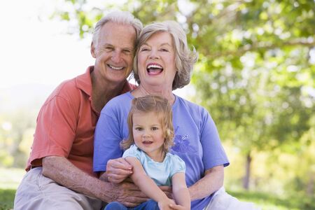 Grandparents with granddaughter in park