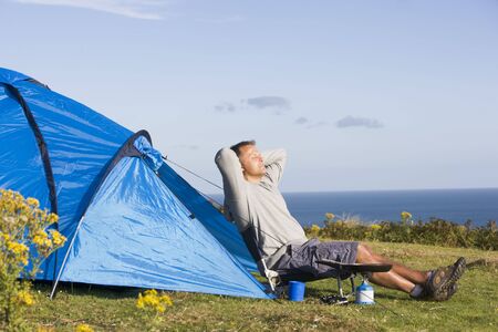 Man camping outdoors and cookingの写真素材