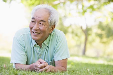 Man relaxing outdoors smilingの写真素材