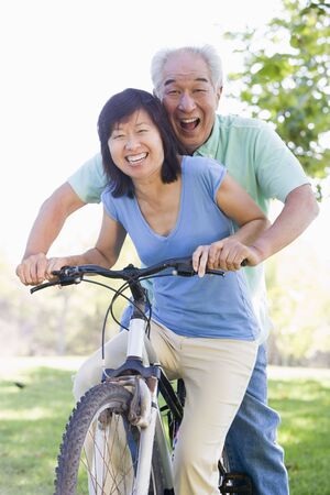 Mature couple bike riding.の写真素材