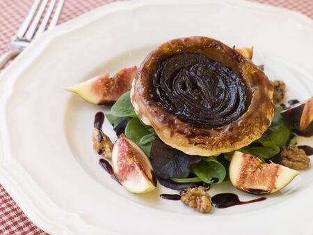 Red Onion Tarte Tatin with Walnuts Figs and Red Wine Syrupの写真素材
