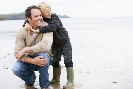 Father and son at beach smilingの写真素材