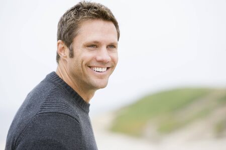 Man standing at beach smiling