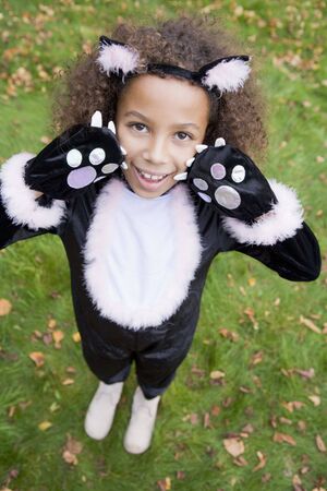 Young girl outdoors in cat costume on Halloweenの写真素材